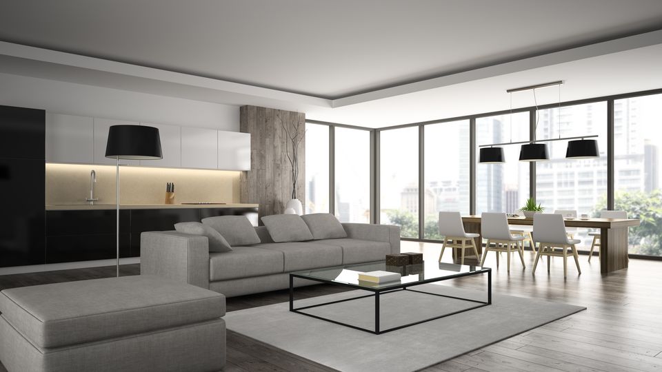 An open-plan condo living space with floor-to-ceiling windows