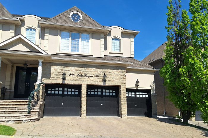 A detached family home with a double garage on a sunny day