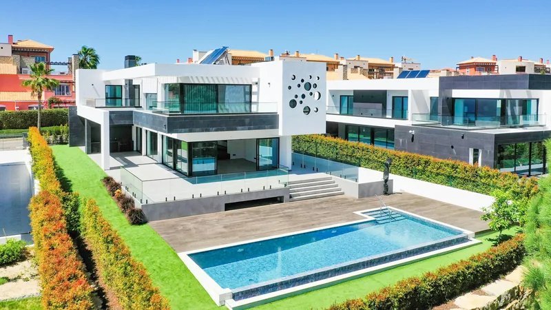 Contemporary white home with glass balconies and a pool